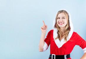 closeup of caucasian happy woman wearing santa clothes laughing pointing finger photo