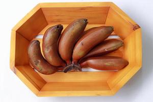 Healthy banana isolated on wooden background photo