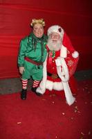 LOS ANGELES, NOV 28 - Michael Lee Gogin, as Christmas Elf Tom Connaghan, as Santa Claus arrives at the 2010 Hollywood Christmas Parade at Hollywood Boulevard on November 28, 2010 in Los Angeles, CA photo