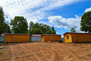 Construction of small yellow wooden frame prefabricated pre-fabricated eco-house of suburban modular fast-growing houses, buildings, cottages. Industrial builde photo