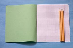 Top view of blank paper with pencils. Pencils on a notebook sheet. Space for text. photo