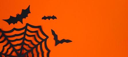 Happy Halloween. Paper bats on orange background. photo