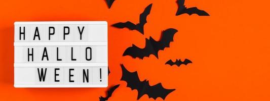 Happy Halloween. Paper bats on orange background. photo