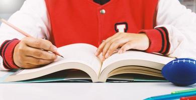 student writing and reading book photo