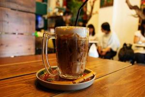 coffee on wooden table in cafe photo