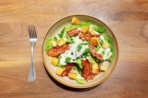 ceasar salad with bacon and bread photo