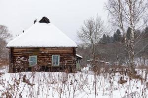 snow covered wooden rustic house photo