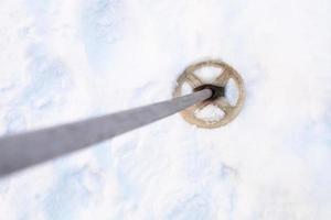top view of the old ski pole in snowy field photo