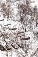 above view of snow covered cars in parking lots photo