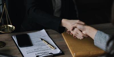 Closeup businesswoman Shaking hands with lawyer after discussing good deal in office photo