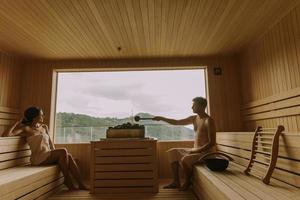 Young couple relaxing in the sauna photo