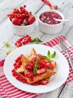 French toast with berries and jam for breakfast photo