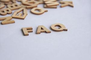 FAQ text on white background. Question and answer concept photo