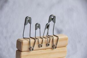 Model safety pin of family sitting on wooden blocks. Family concept photo