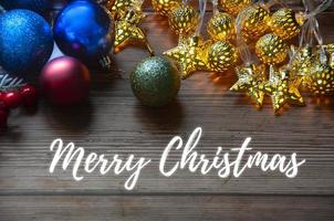 Merry Christmas text with Christmas light and decorations background. Christmas and season's greetings concept. photo