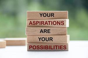 Inspirational words on wooden blocks - Your aspirations are you possibilities. Inspirational and motivational concept photo