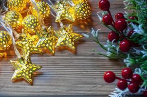 Christmas light and decorations on wooden table background with customizable space for text. Copy space photo