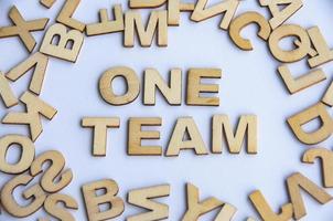 One team wooden text on while cover background. Teamwork concept photo