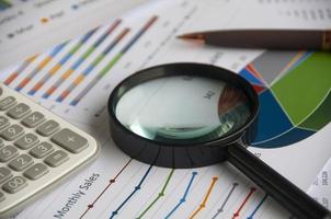 Magnifying glass on graph analysis. Copy space and business analysis concept photo
