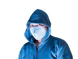 Asian man in hoodie and mask with big eyes threatening scary face in white background, clipping path photo