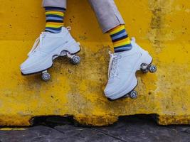 Close-up view of shoe skates against yellow concrete wall photo