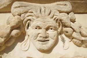 Ancient Mask Relief in Aphrodisias Ancient City in Aydin, Turkiye photo