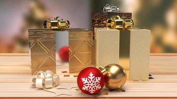 The Christmas balls and gift box on wood table for holiday concept photo
