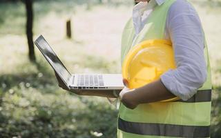 Construction engineer working at blueprint to build large commercial buildings in office. Engineering tools and construction concept. photo
