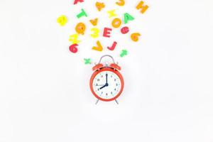 Alarm clock and multicolor alphabet photo