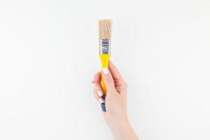 Woman hand holding new paint brush isolated photo