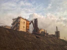 coal factory on a mountain with white clouds photo