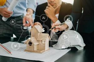 Close up shot of scale model house on table with architects. Two architects making architectural model in office together. to form a new buildin photo