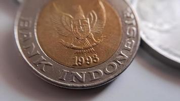One thousand rupiah coin from Indonesia with the palm oil symbol isolated on white background, Diterbitkan oleh bank Indonesia pada tahun 1993 photo