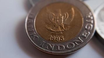 One thousand rupiah coin from Indonesia with the palm oil symbol isolated on white background, Diterbitkan oleh bank Indonesia pada tahun 1993 photo