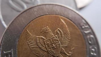 One thousand rupiah coin from Indonesia with the palm oil symbol isolated on white background, Diterbitkan oleh bank Indonesia pada tahun 1993 photo