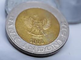 One thousand rupiah coin from Indonesia with the palm oil symbol isolated on white background, Diterbitkan oleh bank Indonesia pada tahun 1993 photo