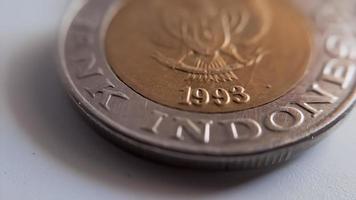 One thousand rupiah coin from Indonesia with the palm oil symbol isolated on white background, Diterbitkan oleh bank Indonesia pada tahun 1993 photo