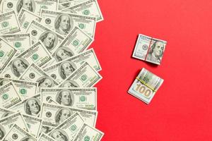 Heap of hundred Dollar Bills on colored background top view, with empty place for your text business money concept photo
