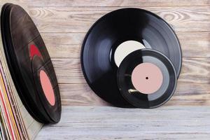 Vinyl record in front of a collection of albums, vintage process. Copy space for text. photo