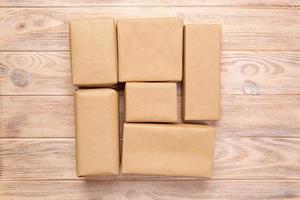 Brown mail package parcel blank for you design. Cardboard box on a wooden background photo