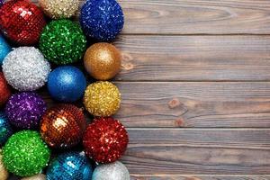 Top view decorative balls in rows on wooden background. Christmas toys concept with empty space for your design photo