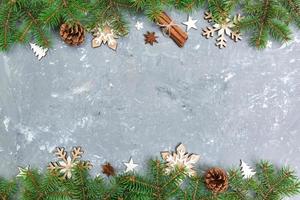 Christmas background with fir tree and snowflaces on gray cement table. Top view with copy space for your design photo