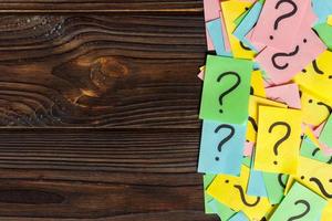 Concept for confusion, question or solution. question mark on wooden background photo