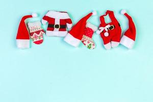 Top view red Santa hats on colorful background. Time for holiday concept with empty space for your design photo