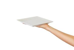 Blank white square matte plate in female hand. perspective view, isolated on white background photo