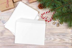 Empty envelope with wishlist for Santa Claus laid on a wooden table photo