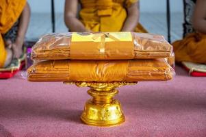 set of monk's robes placed on the pedestal photo