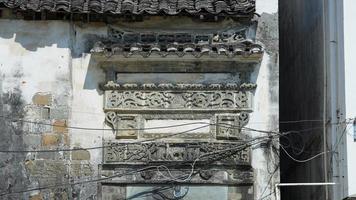 The beautiful traditional Chinese village view with the classical architecture and fresh green trees as background photo