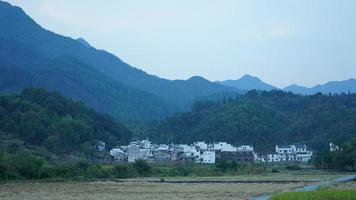 The beautiful traditional Chinese village view with the classical architecture and fresh green trees as background photo