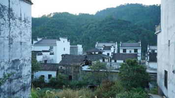 The beautiful traditional Chinese village view with the classical architecture and fresh green trees as background photo